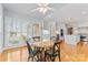 Charming breakfast area with a round table and chairs, surrounded by large windows and opening to a modern kitchen at 10809 Wicklow Brook Ct, Charlotte, NC 28277