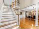 Inviting foyer with staircase, hardwood floors, and elegant dining area beyond at 10809 Wicklow Brook Ct, Charlotte, NC 28277