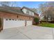 Attached three-car garage showcasing ample parking and convenient access to the home at 10809 Wicklow Brook Ct, Charlotte, NC 28277
