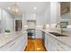 Well-appointed kitchen featuring granite countertops, stainless steel appliances, and a view of the staircase at 10809 Wicklow Brook Ct, Charlotte, NC 28277