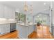 Bright kitchen with a center island, modern appliances, and a breakfast nook with expansive windows at 10809 Wicklow Brook Ct, Charlotte, NC 28277