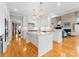 Elegant kitchen with a center island, stainless steel appliances, pendant lighting, and hardwood floors at 10809 Wicklow Brook Ct, Charlotte, NC 28277