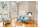 Spacious living area with large windows, natural light, hardwood flooring, and a comfortable seating arrangement at 10809 Wicklow Brook Ct, Charlotte, NC 28277