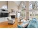 Bright living room with vaulted ceilings, fireplace, and floor-to-ceiling windows showcasing outdoor views at 10809 Wicklow Brook Ct, Charlotte, NC 28277