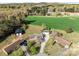 An aerial view captures a home with multiple structures and lots of lush greenery, including a large green field at 1104 Crestview Dr, Salisbury, NC 28146