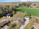 Aerial view showcases the property with detached garage, black outbuilding, and green field at 1104 Crestview Dr, Salisbury, NC 28146