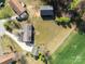 Aerial shot displays a home with a long driveway, fenced backyard, and neighboring properties amidst trees and greenery at 1104 Crestview Dr, Salisbury, NC 28146