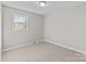 The neutral bedroom features a standard closet, carpet and one window, making it ideal for rest at 1104 Crestview Dr, Salisbury, NC 28146