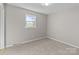 This simple bedroom has neutral walls, carpet, one window, and a radiator, perfect for relaxation at 1104 Crestview Dr, Salisbury, NC 28146