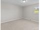 Carpeted bedroom offers neutral walls, a window, and electrical outlets at 1104 Crestview Dr, Salisbury, NC 28146