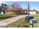 Traditional home with a well-manicured lawn, mature tree, and detached garage at 1104 Crestview Dr, Salisbury, NC 28146