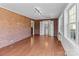 Spacious room with brick walls, large windows for natural light, track lighting, and hardwood floors at 1104 Crestview Dr, Salisbury, NC 28146