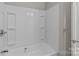 Shower with white surround features built-in shelves and a modern shower head at 1104 Crestview Dr, Salisbury, NC 28146