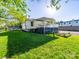 Well maintained backyard features a bright green lawn and a covered deck with white rails at 1114 Herrin Ave, Charlotte, NC 28205