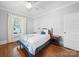 This cozy bedroom features wood floors, bright lighting, a white door, and a comfortable bed at 1114 Herrin Ave, Charlotte, NC 28205