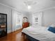 Bright bedroom featuring wood floors, a ceiling fan, and two windows providing natural light at 1114 Herrin Ave, Charlotte, NC 28205
