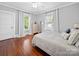 Bright bedroom with hardwood floors, white walls, and plenty of natural light from two large windows at 1114 Herrin Ave, Charlotte, NC 28205