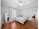 Bright bedroom features hardwood floors, white walls, ceiling fan, and plenty of natural light from large windows at 1114 Herrin Ave, Charlotte, NC 28205