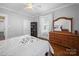 Charming bedroom with wood floors, soft gray walls, a wooden dresser with mirror, and built-in bookcase at 1114 Herrin Ave, Charlotte, NC 28205