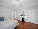 Bright bedroom with hardwood floors, white walls, and decorative fireplace with peacock art at 1114 Herrin Ave, Charlotte, NC 28205
