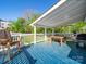 Covered outdoor deck with wood flooring, white rails, outdoor seating, and an outdoor grill at 1114 Herrin Ave, Charlotte, NC 28205