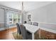 Dining room boasts hardwood floors, a chandelier, and a sun-drenched window at 1114 Herrin Ave, Charlotte, NC 28205