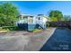 Exterior of home with a blue and white deck surrounded by trees and green lawn at 1114 Herrin Ave, Charlotte, NC 28205