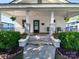 Classic front porch with potted plants and hanging baskets creating a welcoming entrance at 1114 Herrin Ave, Charlotte, NC 28205