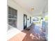 Inviting covered porch with decorative tile flooring, seating, and windows overlooking the neighborhood at 1114 Herrin Ave, Charlotte, NC 28205