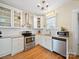 Updated kitchen features stainless steel appliances, white cabinets, granite countertops and hardwood flooring at 1114 Herrin Ave, Charlotte, NC 28205
