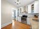 Updated kitchen features stainless steel appliances, white cabinets, granite countertops and hardwood flooring at 1114 Herrin Ave, Charlotte, NC 28205