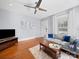 Bright living room with hardwood floors, a modern ceiling fan, and comfortable seating arrangement at 1114 Herrin Ave, Charlotte, NC 28205