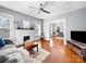Cozy living room featuring hardwood floors, a fireplace, and ample natural light at 1114 Herrin Ave, Charlotte, NC 28205