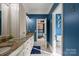 Bathroom with double vanity, granite countertops, and a view into the bedroom suite at 11236 Mcclure Manor Dr, Charlotte, NC 28277