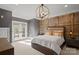 Bedroom features a wood accent wall, neutral colored walls, and light-filled french doors at 11236 Mcclure Manor Dr, Charlotte, NC 28277