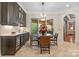 Beautiful dining area featuring a wet bar, access to the patio, and neutral tones at 11236 Mcclure Manor Dr, Charlotte, NC 28277