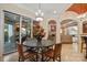 Elegant dining area features a chandelier, access to the patio, and views into the living room and kitchen at 11236 Mcclure Manor Dr, Charlotte, NC 28277