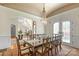 Formal dining room with an ornate table and chandelier, leading to the foyer and living room at 11236 Mcclure Manor Dr, Charlotte, NC 28277