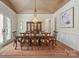 Formal dining room with decorative ceiling, elegant chandelier, and large wood table at 11236 Mcclure Manor Dr, Charlotte, NC 28277