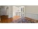 Grand foyer features hardwood floors, detailed trim, and a decorative chandelier over curved balcony at 11236 Mcclure Manor Dr, Charlotte, NC 28277