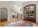 Foyer with a staircase, chandelier, front door, wood floors, and decorative rug at 11236 Mcclure Manor Dr, Charlotte, NC 28277