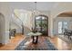 Foyer with curved staircase, chandelier, hardwood floors, and glass-paneled front door at 11236 Mcclure Manor Dr, Charlotte, NC 28277