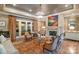 Warm living room with fireplace, chandelier, and French doors at 11236 Mcclure Manor Dr, Charlotte, NC 28277