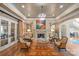 Elegant living room with fireplace, chandelier, and French doors at 11236 Mcclure Manor Dr, Charlotte, NC 28277
