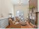 Bright sitting room featuring a fireplace, chandelier, and French doors at 11236 Mcclure Manor Dr, Charlotte, NC 28277