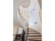 A sweeping curved staircase featuring a decorative railing and a window with panes at 11236 Mcclure Manor Dr, Charlotte, NC 28277