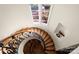 Elegant spiral staircase with hardwood steps and ornate iron railing, leading to the upper levels at 11236 Mcclure Manor Dr, Charlotte, NC 28277
