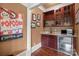 Wet bar area featuring granite countertops, custom wine racks, and a beverage refrigerator at 11236 Mcclure Manor Dr, Charlotte, NC 28277