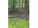 View of a sloped backyard with wood steps leading uphill at 113 Duval Ct, Mooresville, NC 28117