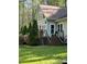 Exterior view of a house with a deck and stairs, surrounded by greenery, offering a relaxing outdoor living space at 113 Duval Ct, Mooresville, NC 28117